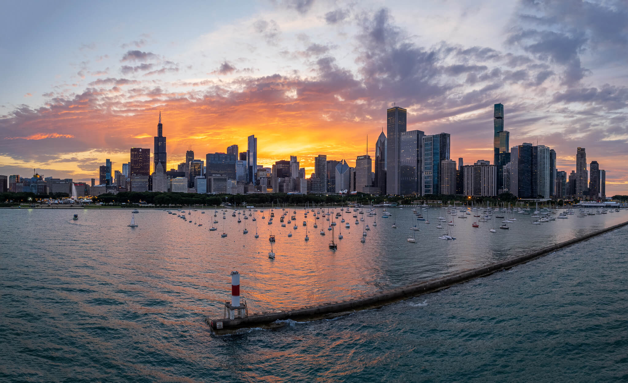 Chicago skyline silhouette at sunset with sailboats