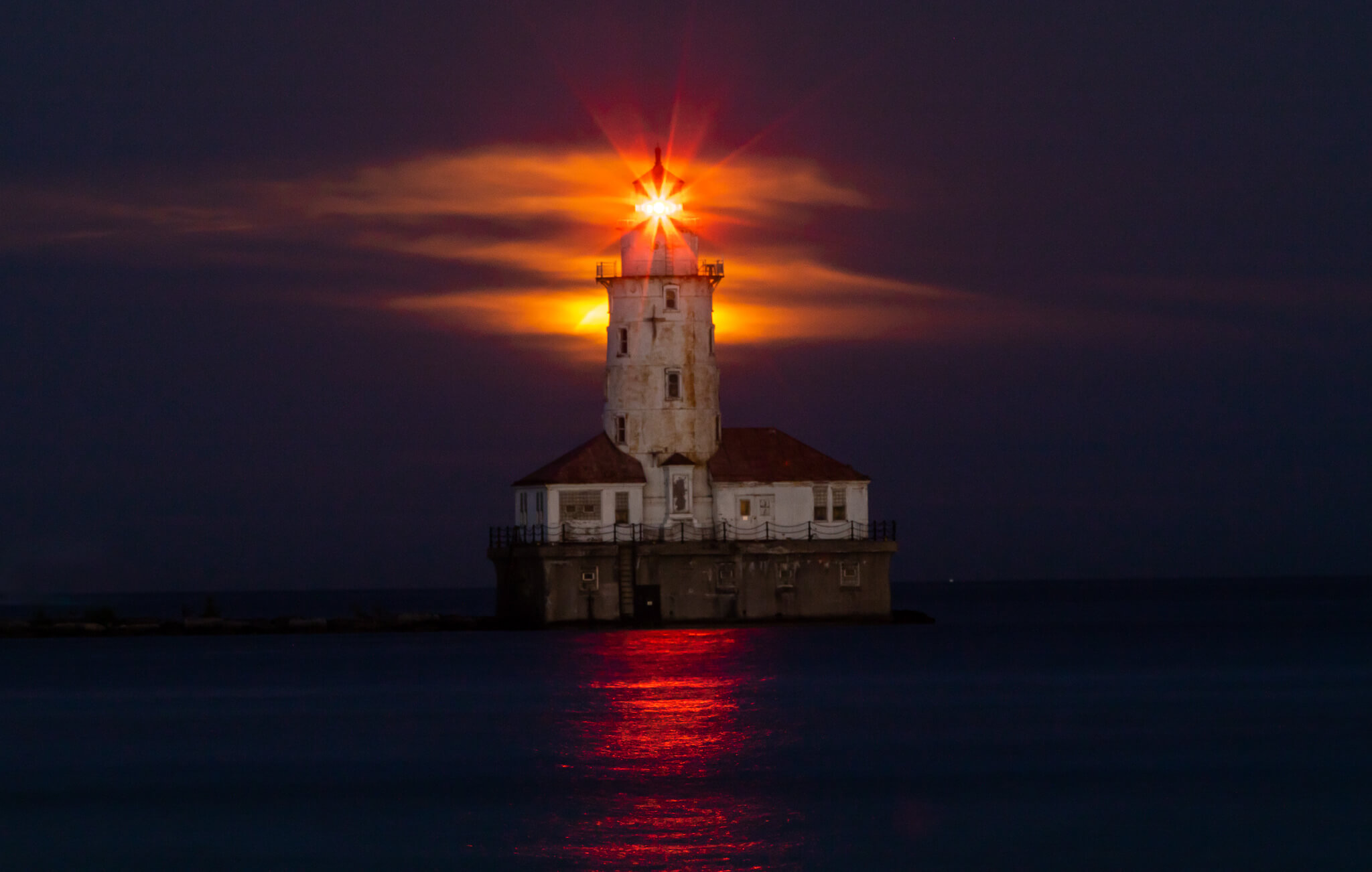 Sailboats moored in marina at sunset on Lake Michigan