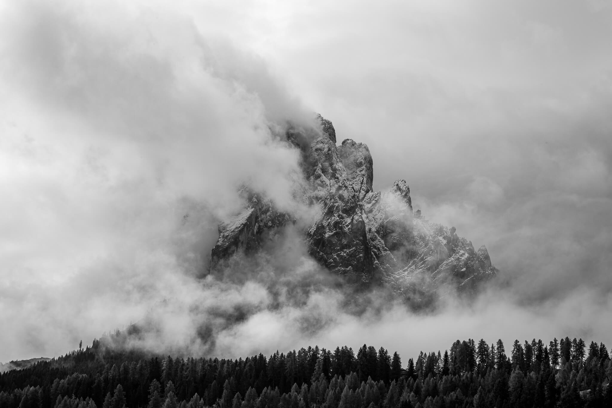 Black and white Dolomite peak emerging from clouds