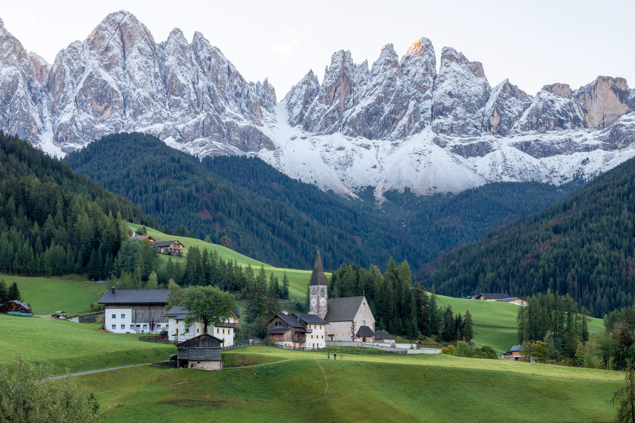 Santa Maddalena village at dusk below snowy Odle peaks