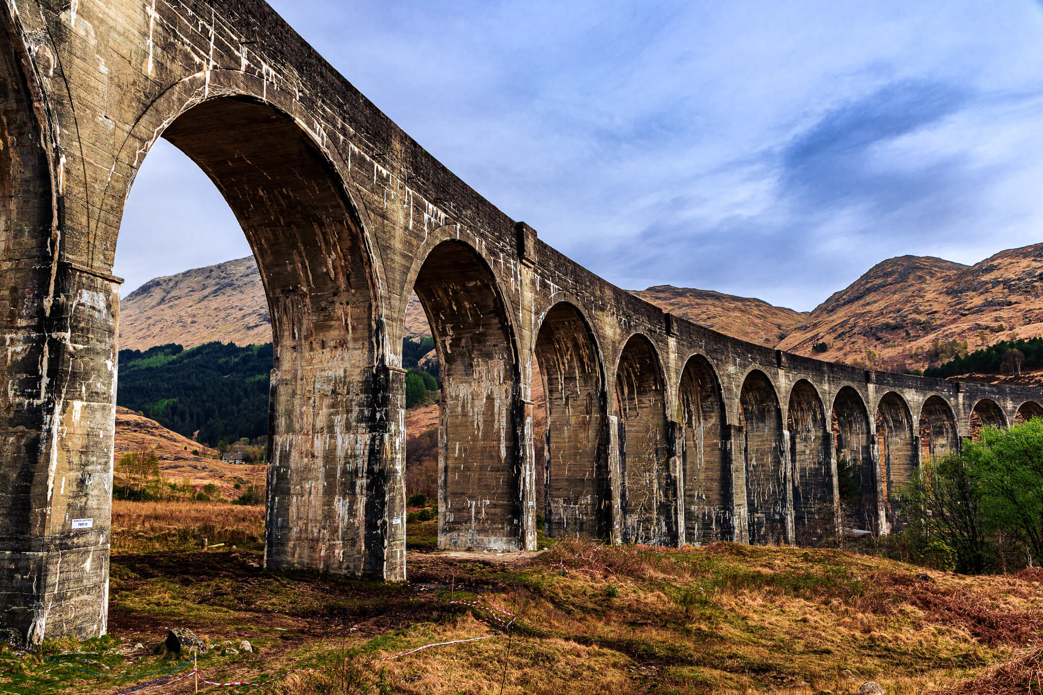 Glenfinnan Viaduct sweeping stone arches against Highland mountains, Scotland